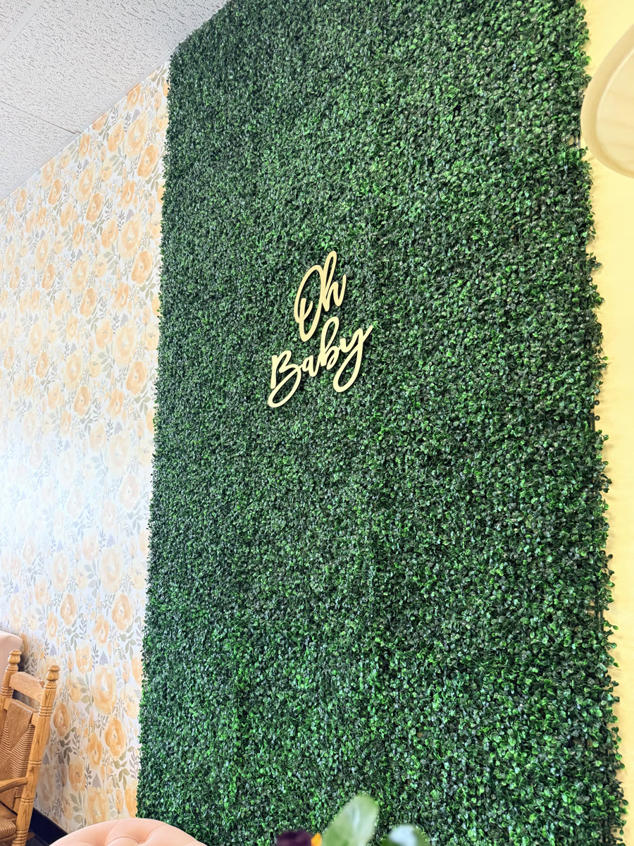 Oh Baby greenery photo wall inside the studio